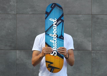 Man Holding Skateboard PSD Mockup